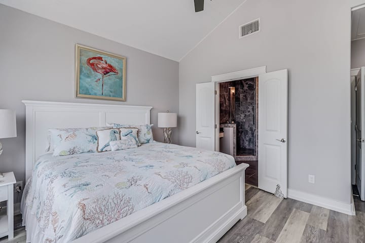 Your coastal bedroom features sea-themed artwork and linens, creating a serene retreat with an ensuite bathroom for ultimate comfort.