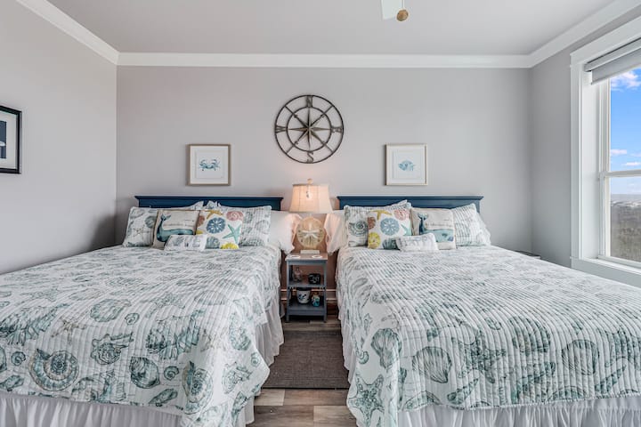 Drift off to sleep in your coastal-themed bedroom where twin beds with nautical linens and ocean views create the perfect seaside retreat.