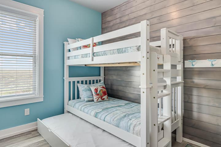 Your coastal-themed bunk room offers comfortable sleeping for the kids, with charming nautical details and a cozy hideaway trundle bed below.