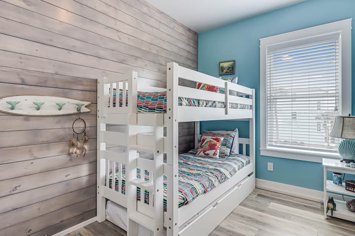 Your kids will love this cheerful bunk room with its coastal-themed decor and cozy sleeping space for memorable family adventures.