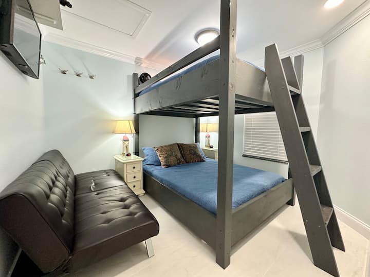 Second bedroom with queen over queen bunk beds. Pack n Play in closet. Futon in the photo was removed 