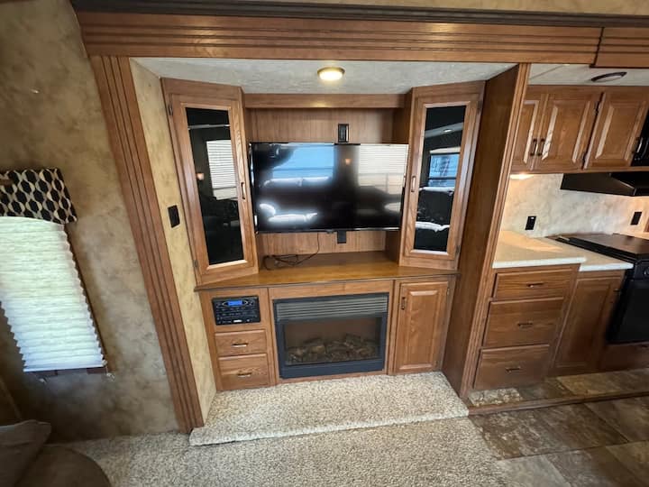 The Livingroom is ready to entertain either with a Large screen HD tv & surround sound audio system or enjoy the electric fireplace on a chilly day.   An eclectic collection of CDS and DVDs augment the 200 plus Channels of Spectrum TV and Netflix.