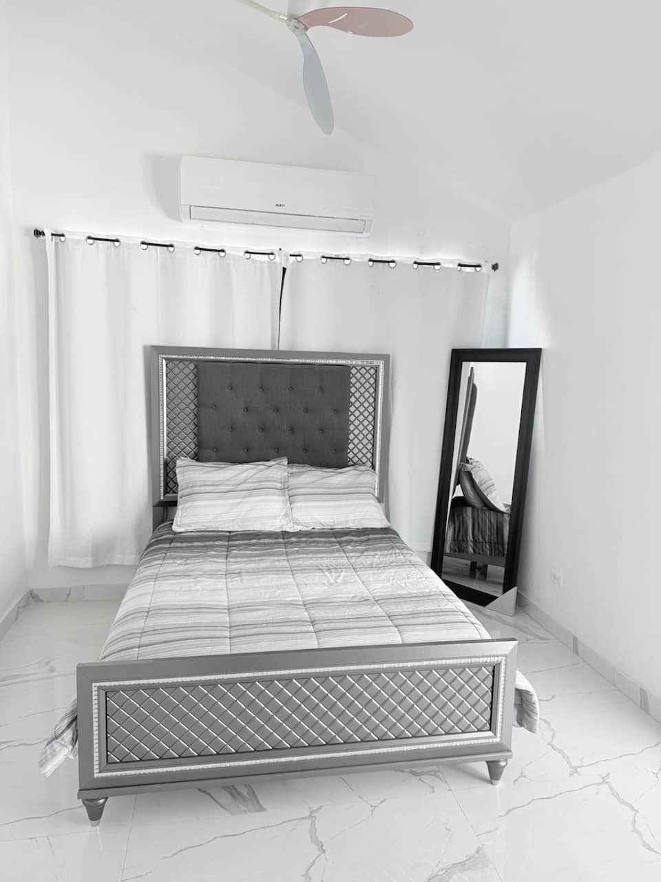 Studio queen bed with a mirrored frame