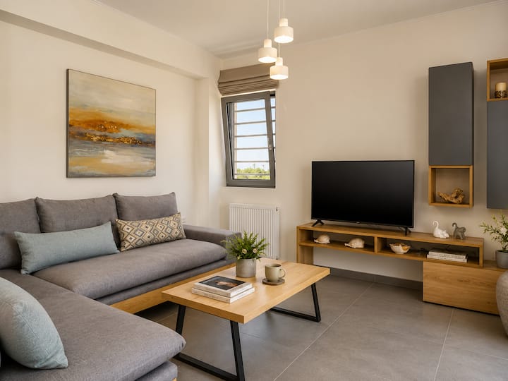 Main Level - Stylish open-plan living area with Smart TV & comfortable corner sofa