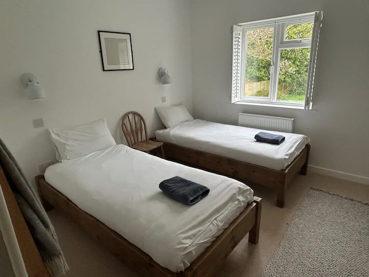 The white room. Two single beds, hanging space and views over the back garden 