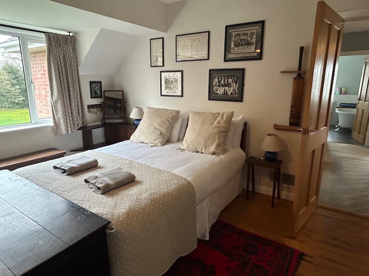 Maryknowl. A large king size bed in a large bedroom overlooking the back garden. Extensive wardrobe and storage space. 