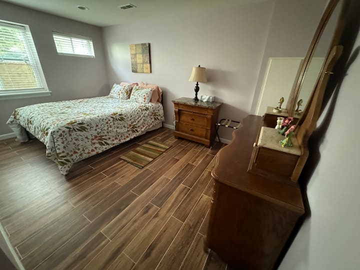 This is the bedroom with the door, closet and large dresser and two bedside tables
