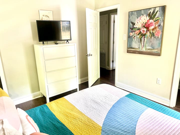 Primary bedroom with attached bathroom and Smart TV