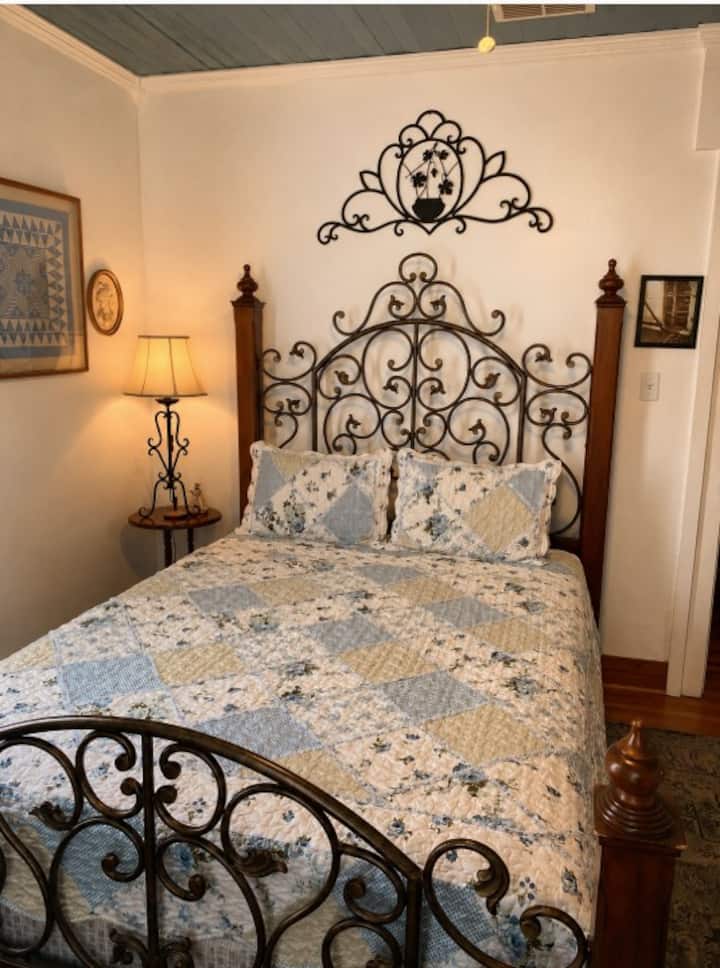 This is the room known as "Amelia's Room". It has a queen size bed with a privacy door leading to the Faust Room.