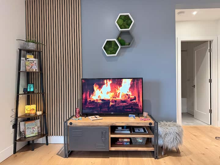 Our living space is designed for comfort and connection, featuring a plush couch from Parliament in Gastown, layered with soft pillows and cozy blankets.