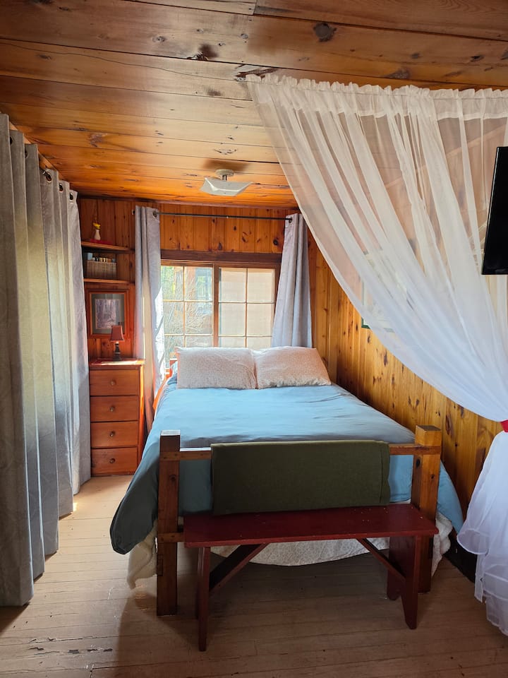 Studio style bedroom just off of the living room with a windows that overlooks the lake.
