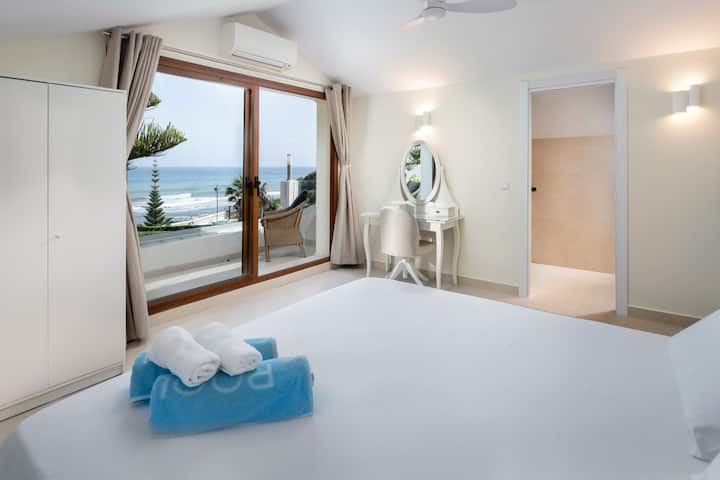 Master bedroom with 180cm king sized bed, en-suite bathroom, dressing table, and private terrace overlooking the sea.
