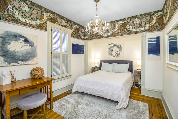 The main floor bedroom features a comfortable queen bed, offering a restful retreat with easy, convenient access. It’s a perfect option for guests who prefer to avoid stairs while still enjoying a spacious and relaxing place to unwind.