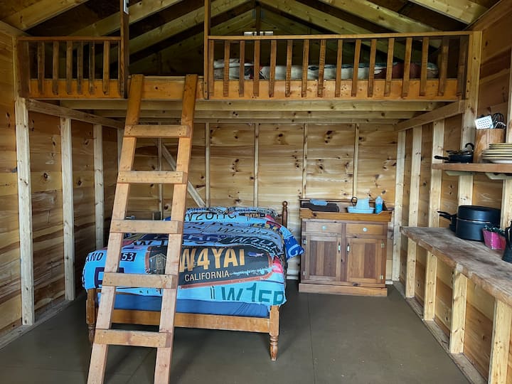 Full size bed on ground floor. Queen bed in the loft.