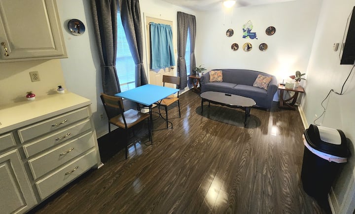 The TV is mounted on the right side wall and can be adjusted to view from the couch or the dining table. Feel free to move the table where you would like it