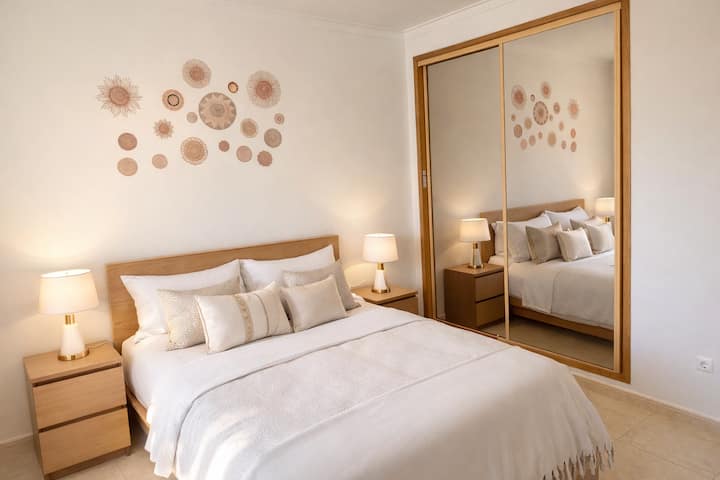 Large bedroom with pool view with a double bed, single bed (convertible armchair)  and  closets