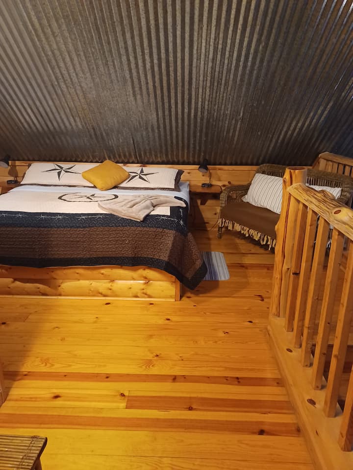 Upstairs king bed in open loft.