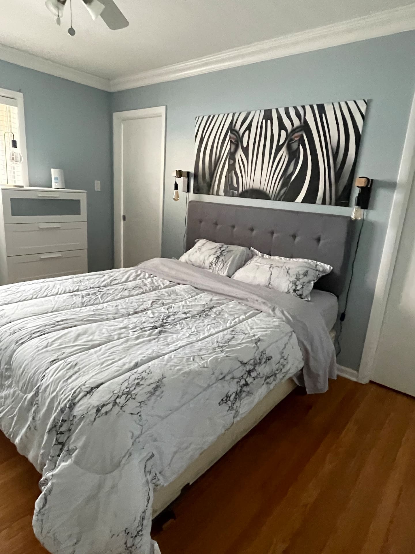A serene bedroom with a queen-size bed, soft linens, and a view of the garden.