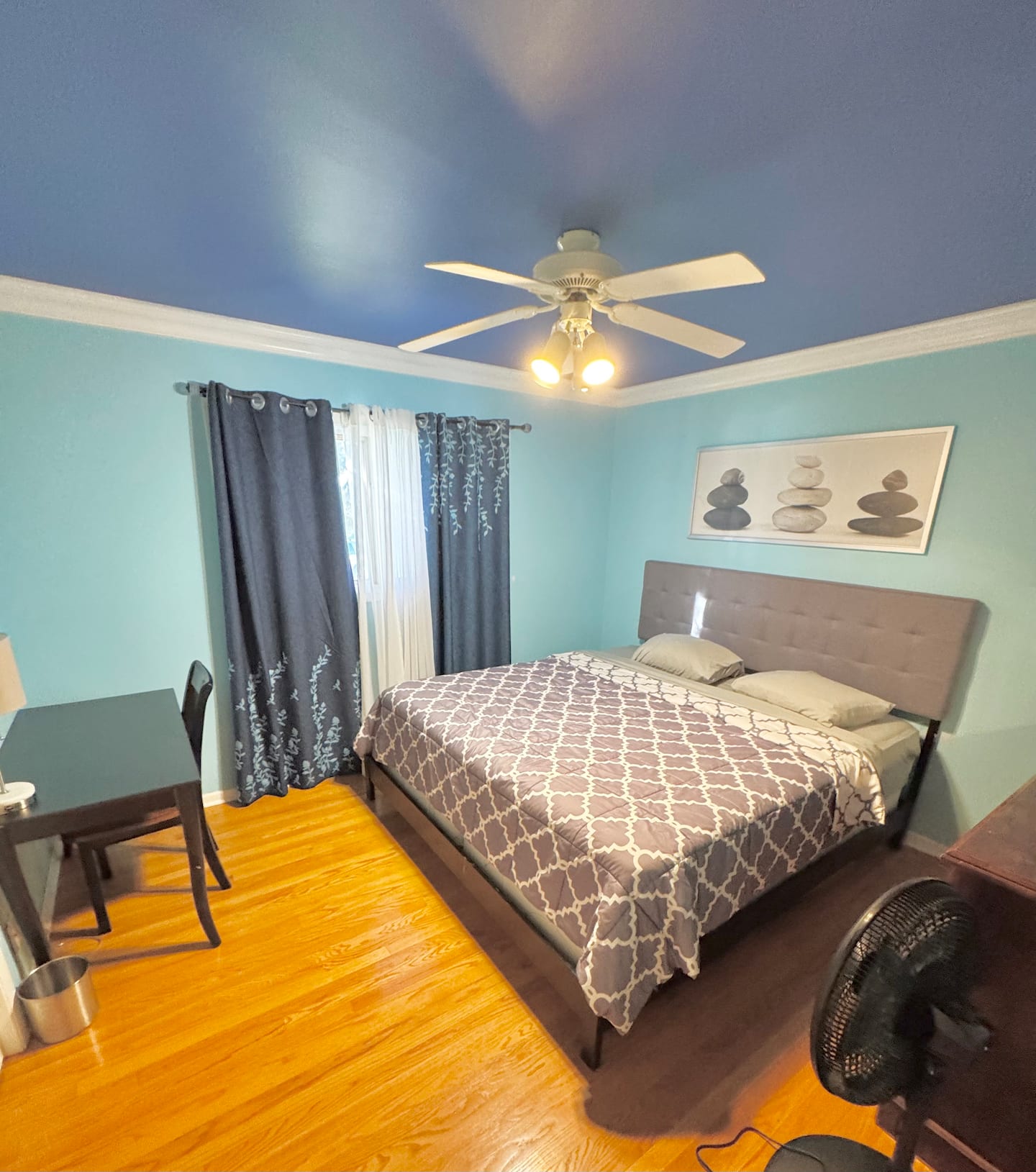 A serene bedroom with a king-size bed, soft linens, and a view of the garden.