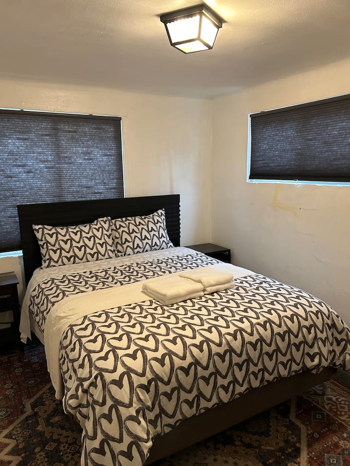 2nd bedroom with a queen bed a TV in downstairs