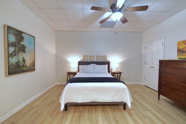 Queen Bedroom #2 sleeps 2 and features access to a full bathroom with double sinks, shared with Queen Bedroom #3. Windowless—ideal for daytime sleeping.