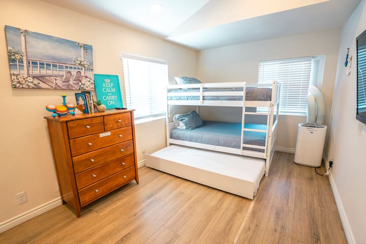 Bunk bed with 2 double beds and 1 pull out trundle single bed on the bottom.
