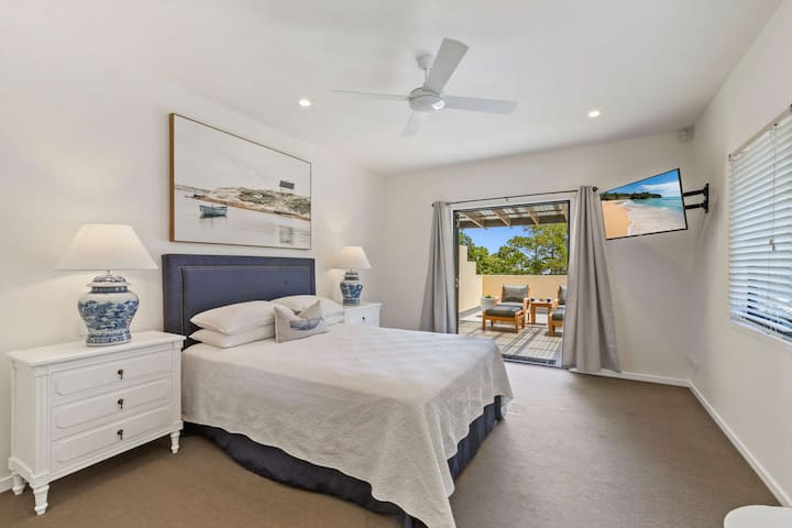 Spacious master bedroom with a comfortable queen sized bed