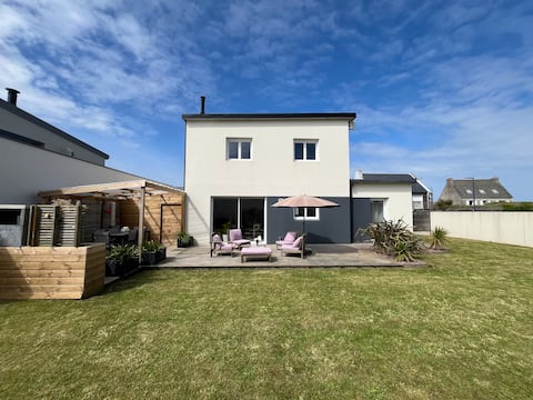 Beachfront house, feet in the sand.