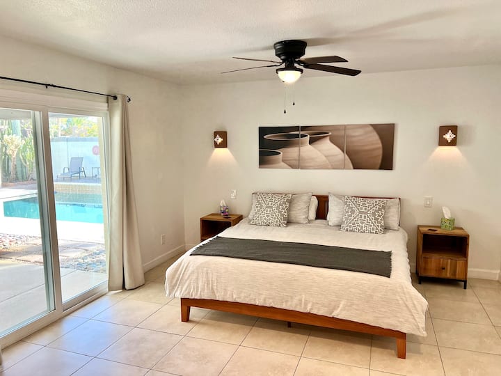 Oversized main bedroom with king bed, walk in closet, sitting area and full size bathroom.  (~500 sqft) Direct access to backyard and pool.