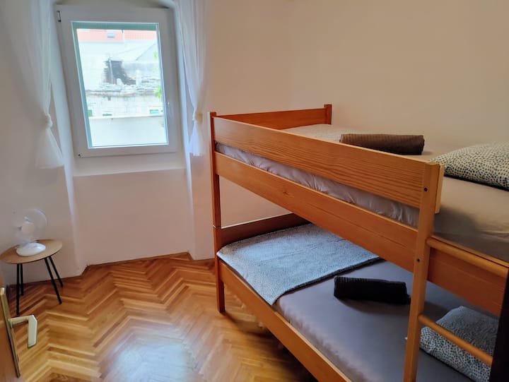 Apartment 1: bunk bed, floor fans available, air conditioning is in the corridor