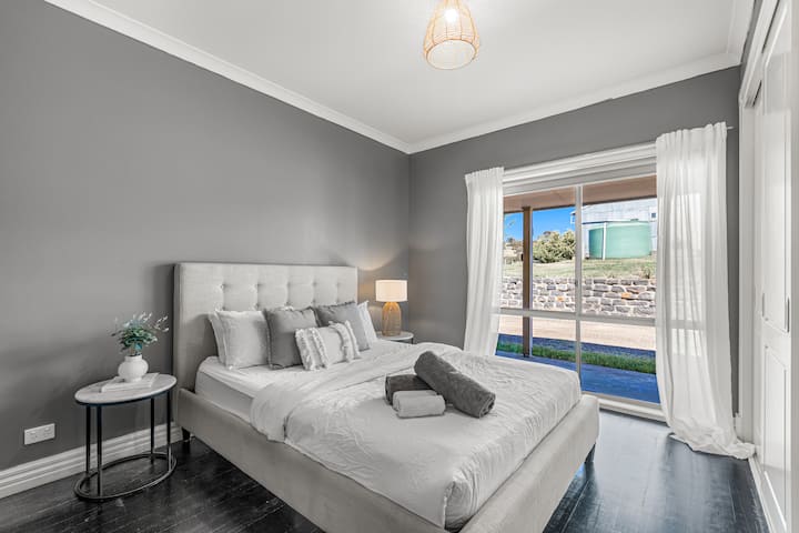 Main farmhouse 2nd bedroom with queen bed