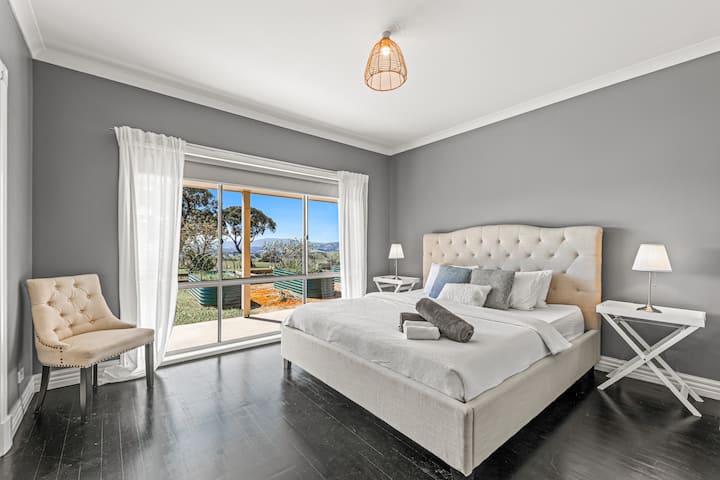 Main farmhouse master suite with king bed, walk-in robe, and private ensuite