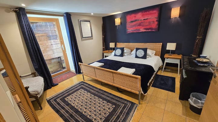 Superking bed on lower ground with direct access into the walled garden.  Shared shower room next door.