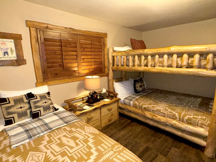 Our queen on queen bunk bed & single bed are layered in buttery soft sheets, luxury pillows, Pottery Barn & Pendleton bedding!