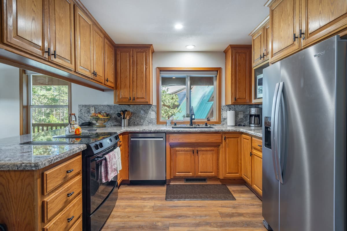 Newe stainless steal appliances and a Jenn-air oven/stove.  LOTS of cabinets full of kitchen utensils, cookware, bowls, glasses, plates, mixer, coffee makers, baking trays, serving trays,  roasting pan, Instant Pot, microwave.