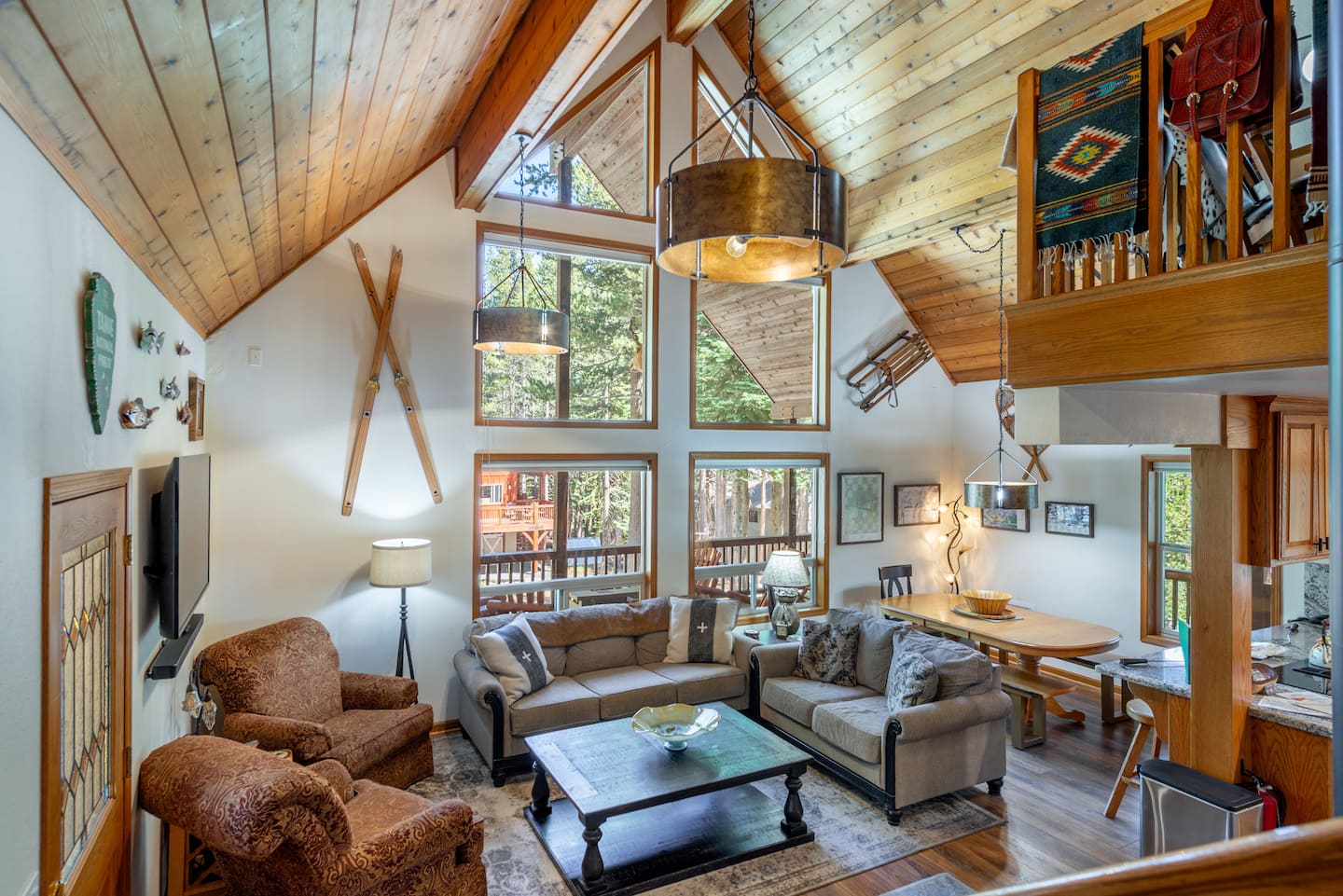 Bright, open living room with high ceilings and large front windows