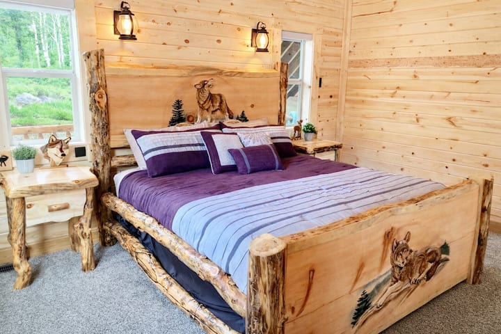 Bedroom 1 downstairs has a King sized handcrafted aspen and pine log bed. This gorgeous solid-wood bed was hand carved by one of the country's best wood carvers. 