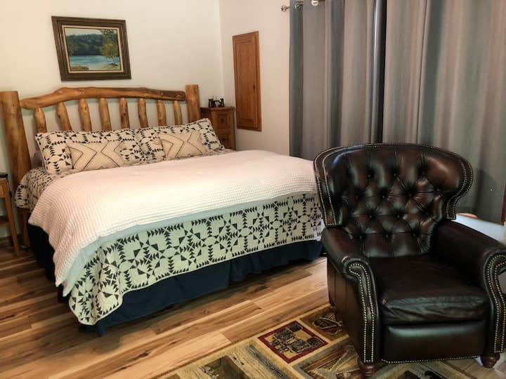 This is the king bed in the master bedroom in the Lodge. This room has a twin bed and a door going out to the back porch that overlooks the river. This room has a master bathroom that joins this room.