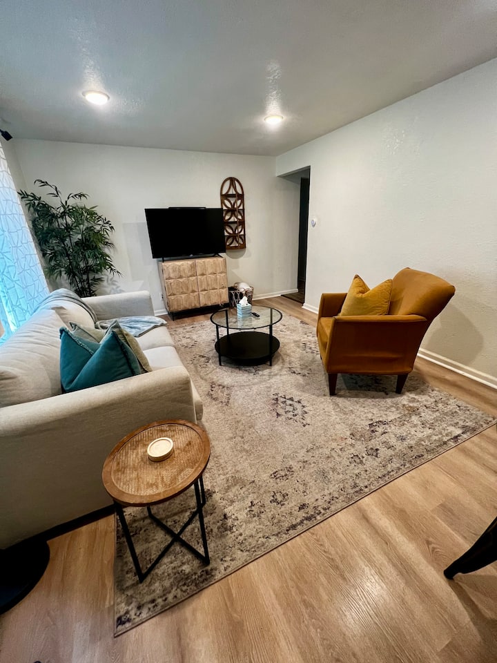 Upstairs living room with a 50 inch smart tv and pull out couch with Queen bed.