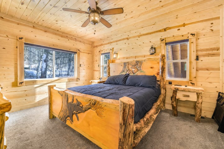 In bedroom one, there is a queen sized bed. The windows have the perfect view of the beautiful trees surrounding the cabin. 