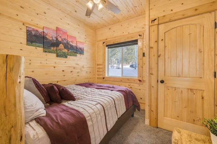 Bedroom #2 with a queen sized bed, plus a straight view out of the window to the beautiful wilderness surrounding the cabin.