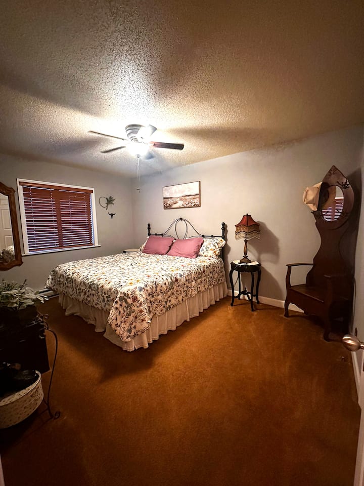 Another king-size bed! The attached walk-in closet contains more blankets, a pack&play for infant/toddler sleeping, a cot with pillow top that can be used, an ironing board and iron, a standing oscillating fan and a hamper for used towels and linens!