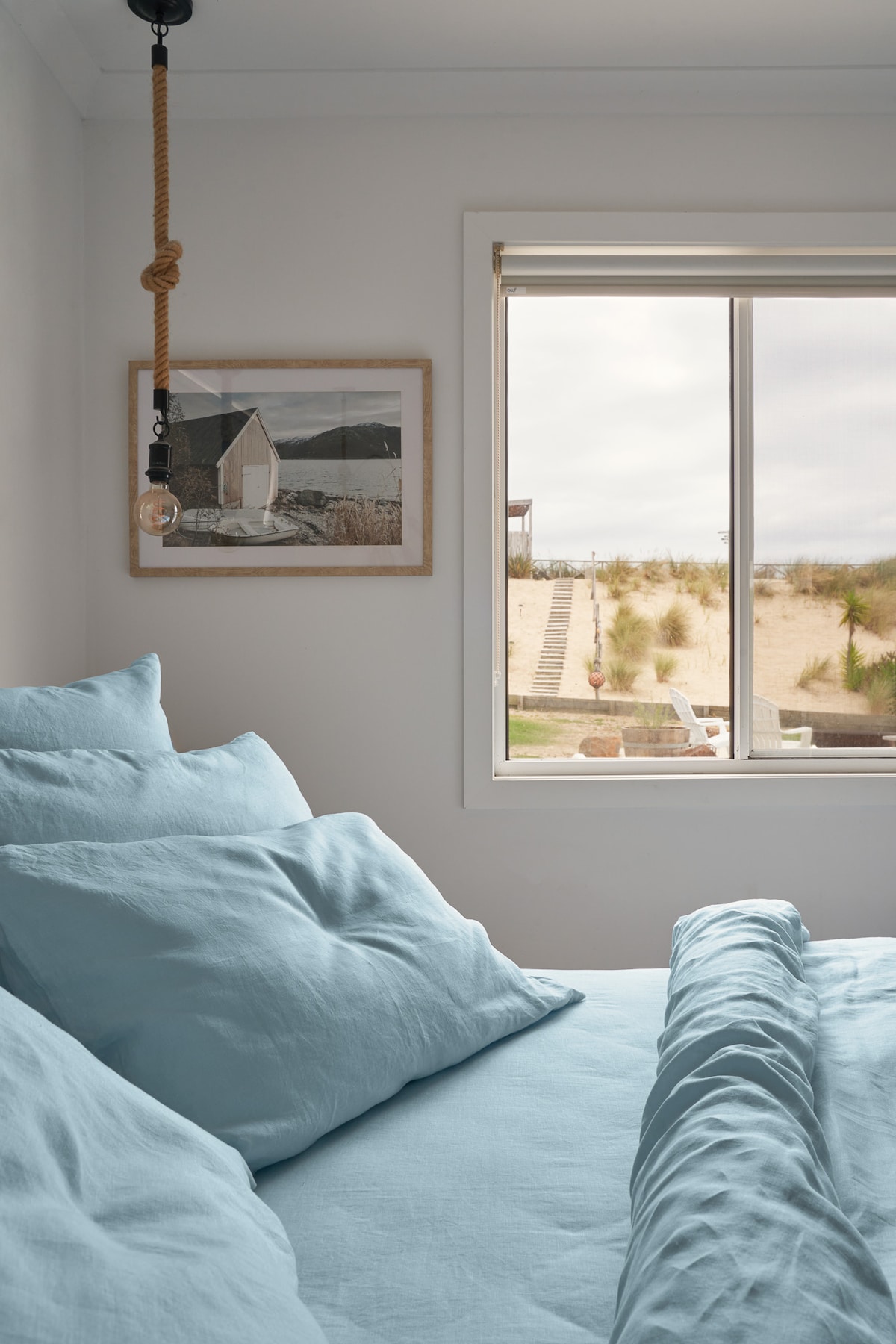 Beautiful bed linen and a view of the sand dunes. 