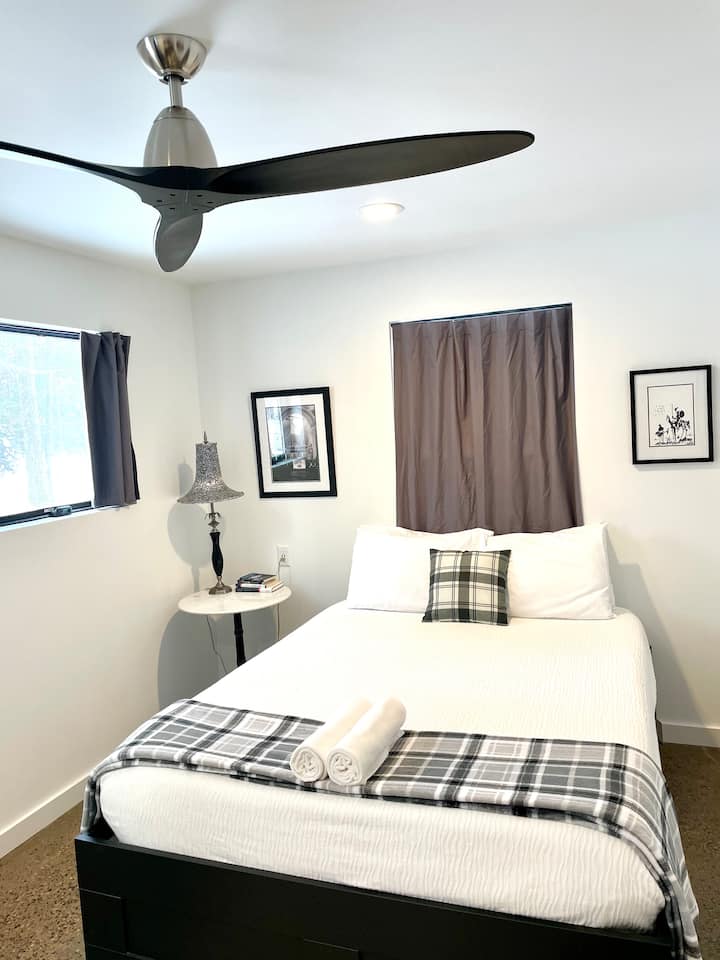 The smallest bedroom of the house has a Queen bed, is on the first floor, and has a full bathroom adjacent to it. 