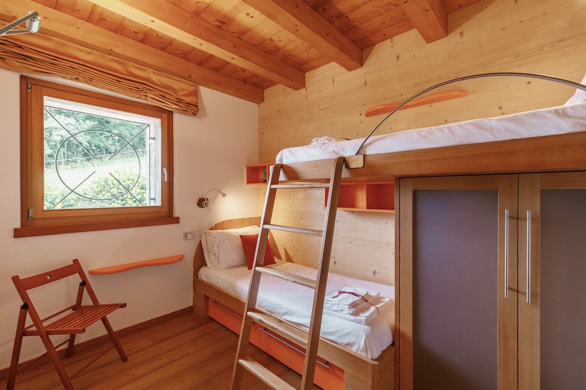 Wooden room with bunk bed.
Custom-made furniture by expert local craftsmen.
Large wardrobe and drawers for storing clothes. 