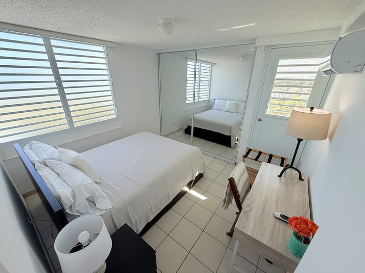 ห้องนอนที่สอง: เตียงควีนไซส์ โต๊ะข้างเตียง โคมไฟข้างเตียง ผ้าปูที่นอนที่เพิ่งซักใหม่ อุปกรณ์ชายหาด เครื่องปรับอากาศสปลิตใหม่ ชั้นวางกระเป๋าเดินทาง ตลอดจนโต๊ะและเก้าอี้ขนาดเล็ก