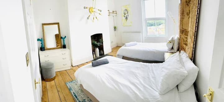 Double the beds, double the giggles — perfect for besties or late-night pillow talk.  twin ensuite bedroom 