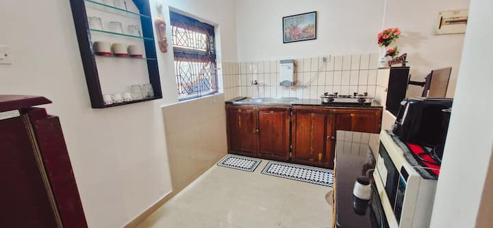Kitchen with cooking facilities, fridge, microwave, kettle, toaster, water filter