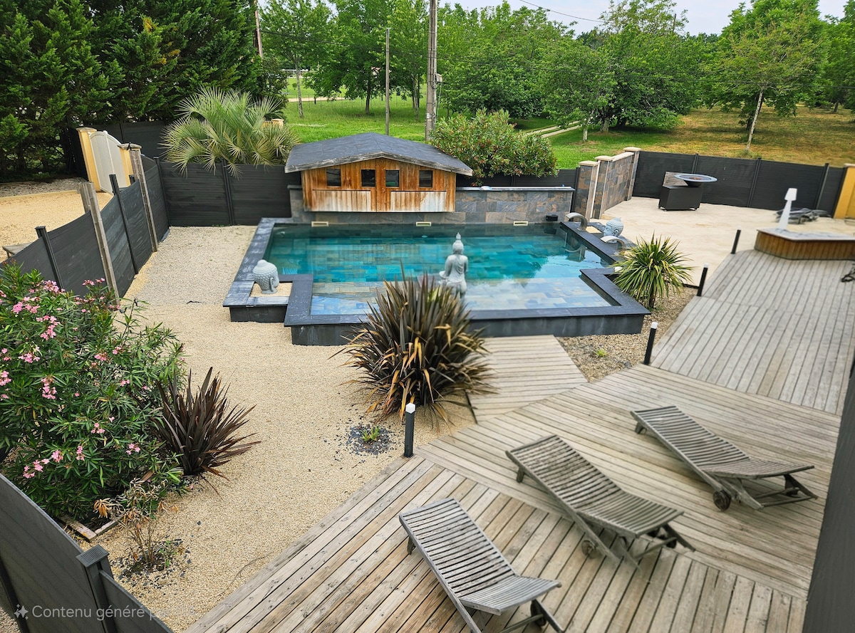 An expansive outdoor setting features a rectangular pool surrounded by wooden decking. Lounge chairs are arranged nearby, and a small wooden structure, resembling a shelter, sits adjacent to the pool. Lush greenery and landscaping elements enhance the serene environment.