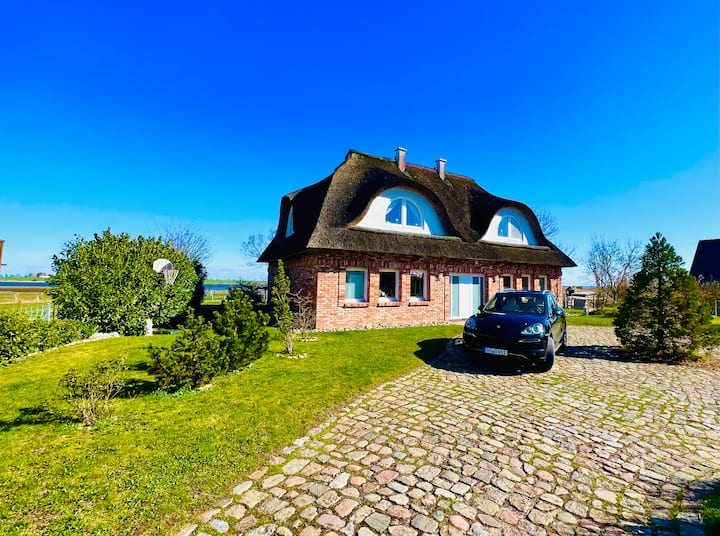 Gorgeous thatched roof house with water views